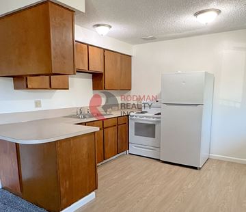 Longview apartment for rent - A kitchen with wooden cabinets and a white refrigerator.