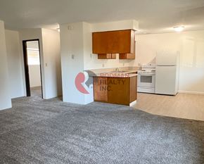 Longview apartment for rent - A room with a brown cabinet and a sign that says "PROUDMAN REALTY INC."