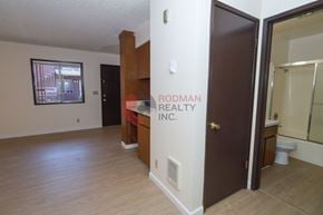 Longview apartment for rent - A room with Rodman Realty Inc. written on the wall.