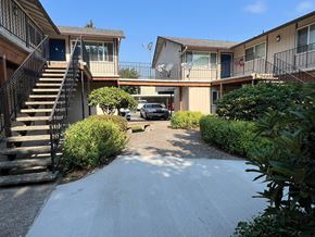 Longview apartment for rent - A car is parked in the driveway of a house with a black metal staircase.