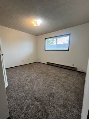 Longview apartment for rent - A room with a carpeted floor and a window.