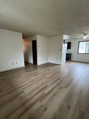 Longview apartment for rent - A room with wooden flooring and a ceiling fan.