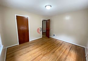 Longview house for rent - A room with wooden floors and two doors.