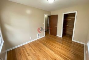 Longview house for rent - A room with wooden floors and a door on the right.