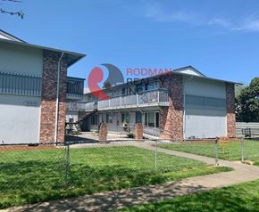 Longview apartment for rent - A building with a sign that reads "RODMAN" is visible.