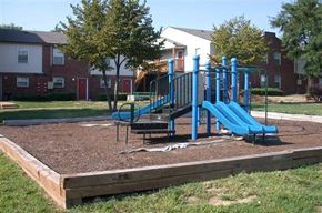 St. Louis apartment for rent - a playground with a blue playset in a park