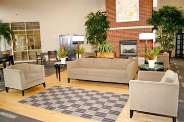 St. Louis apartment for rent - a living room with couches and chairs and a fireplace