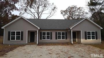 Youngsville apartment for rent - a small gray house with a driveway and some trees