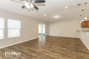 Middleburg house for rent - a living room with a wood floor and a ceiling fan