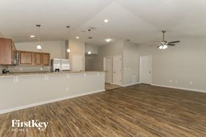 Middleburg house for rent - the living room and kitchen of an empty house with wood flooring