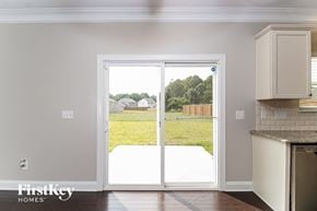 Kernersville house for rent - a kitchen with white cabinets and a sliding glass door