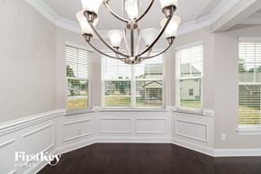Kernersville house for rent - a dining room with a large window and a chandelier