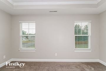 Kernersville house for rent - a living room with two windows and a carpet