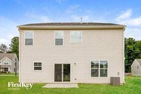 Kernersville house for rent - the backyard of a house with white siding and grass