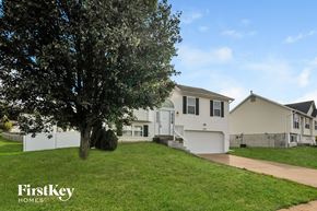 Imperial house for rent - a row of white houses on a hill with a tree
