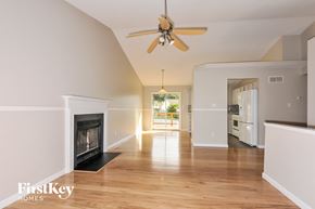 Imperial house for rent - a living room with a fireplace and a ceiling fan