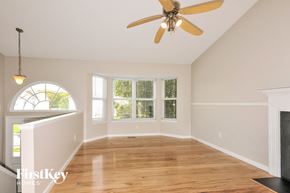 Imperial house for rent - an empty living room with a ceiling fan and a window