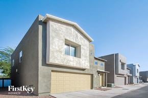 Tucson house for rent - a house with a garage door in front of it