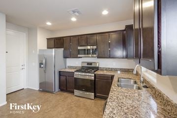 Tucson house for rent - a kitchen with granite counter tops and stainless steel appliances