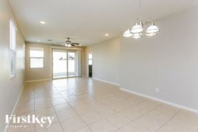 San Tan Valley house for rent - A spacious room with a fan and sliding glass doors.