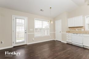 Winston Salem house for rent - a kitchen with white cabinets and a hard wood floor