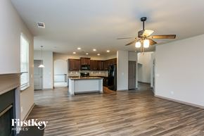 Hoschton house for rent - a kitchen and living room with wood floors and a ceiling fan