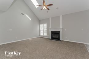Charlotte house for rent - the spacious living room with fireplace and ceiling fan