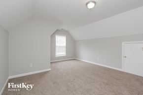 Charlotte house for rent - a bedroom with white walls and carpet and a white door