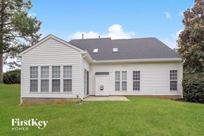Charlotte house for rent - a white house with white siding and a grassy yard
