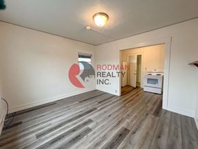 Kelso apartment for rent - A room with Rodman Realty Inc. logo on the wall.
