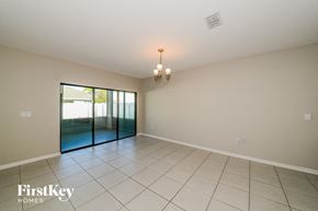 Palmetto house for rent - an empty living room with a sliding glass door to a patio