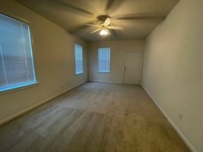 Rocky Mount apartment for rent - A room with a ceiling fan and carpeted floor.