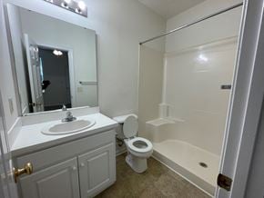 Rocky Mount apartment for rent - A bathroom with a toilet, sink, and shower.