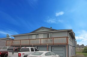 Enumclaw apartment for rent - the front of a house with a parking lot full of cars