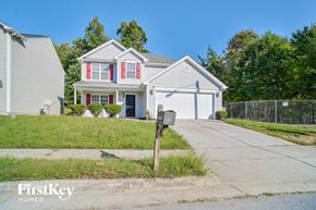 Greensboro house for rent - a white house with red shutters and a mailbox on a sidewalk