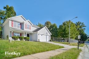 Greensboro house for rent - a white house with red window shutters and a sidewalk
