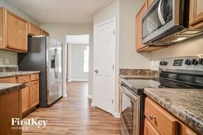 Greensboro house for rent - a kitchen with wooden cabinets and stainless steel appliances