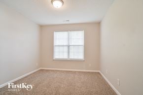 Greensboro house for rent - a spacious room with carpet and a window