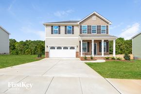 Midland house for rent - a house with a white garage door in front of a lawn