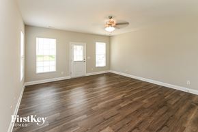 Midland house for rent - the spacious living room with hardwood flooring and a ceiling fan