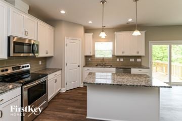 Midland house for rent - an updated kitchen with white cabinets and granite counter tops