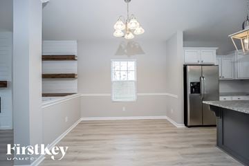 Moncks Corner house for rent - A kitchen with a refrigerator, cabinets, and a window.