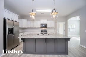 Moncks Corner house for rent - A kitchen with a granite countertop and stainless steel appliances.