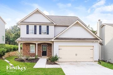 Dallas house for rent - a white and brick house with a white garage door
