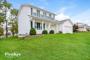 St Charles house for rent - a white house with green shutters and a lawn