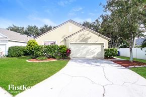 Rockledge house for rent - a white driveway in front of a yellow house with a garage door