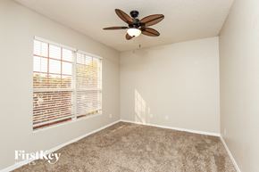 Rockledge house for rent - a bedroom with a ceiling fan and a large window
