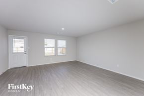 St Hedwig house for rent - the living room of a home with white walls and wood floors