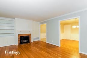 Greensboro house for rent - a living room with a fireplace and wooden floors