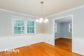 Greensboro house for rent - a living room with wood floors and white walls and a chandelier